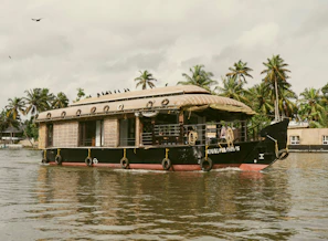 A private balcony on the houseboat with a seating area and panoramic views of the Himalayas.