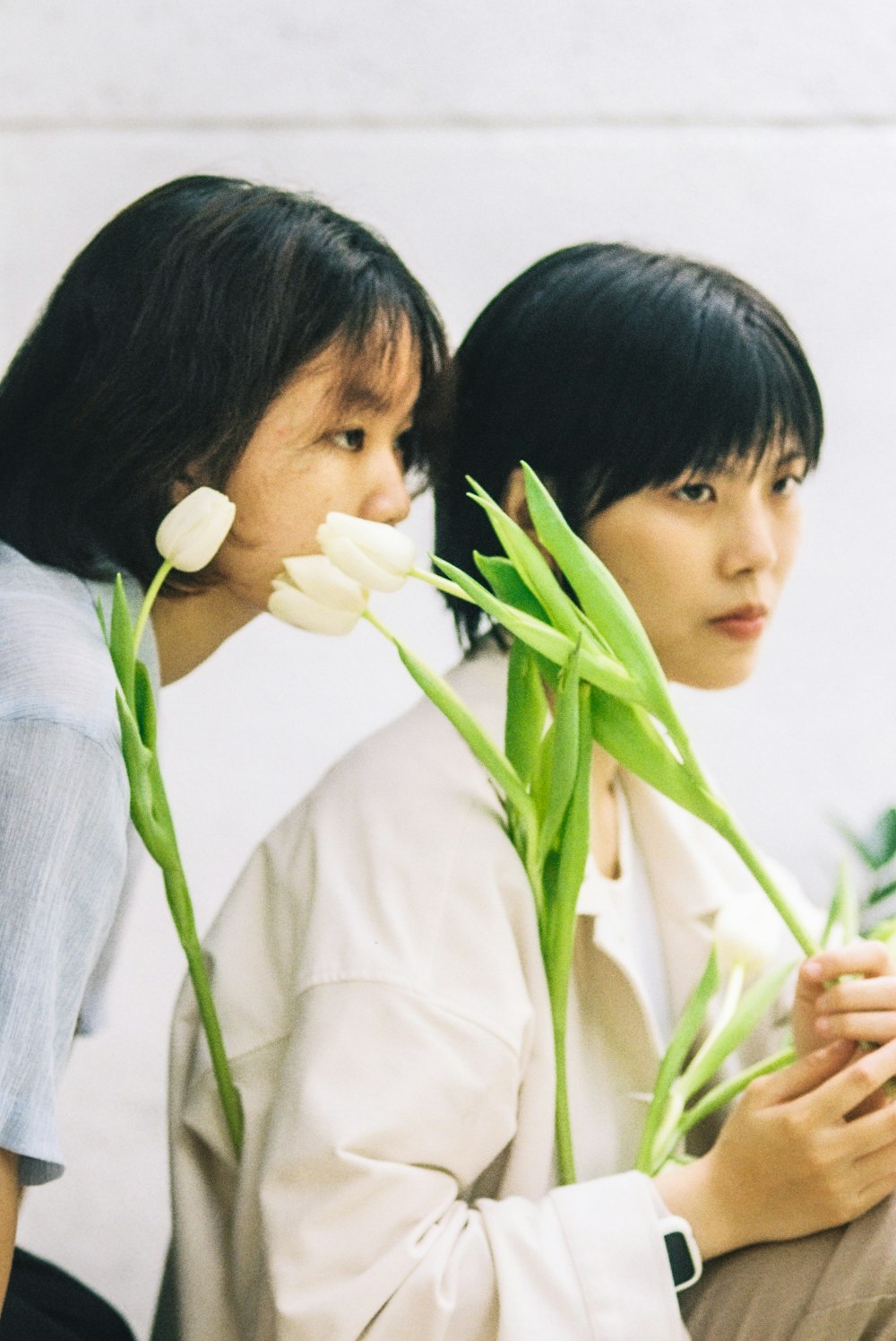 two asian women with flowers in their hair