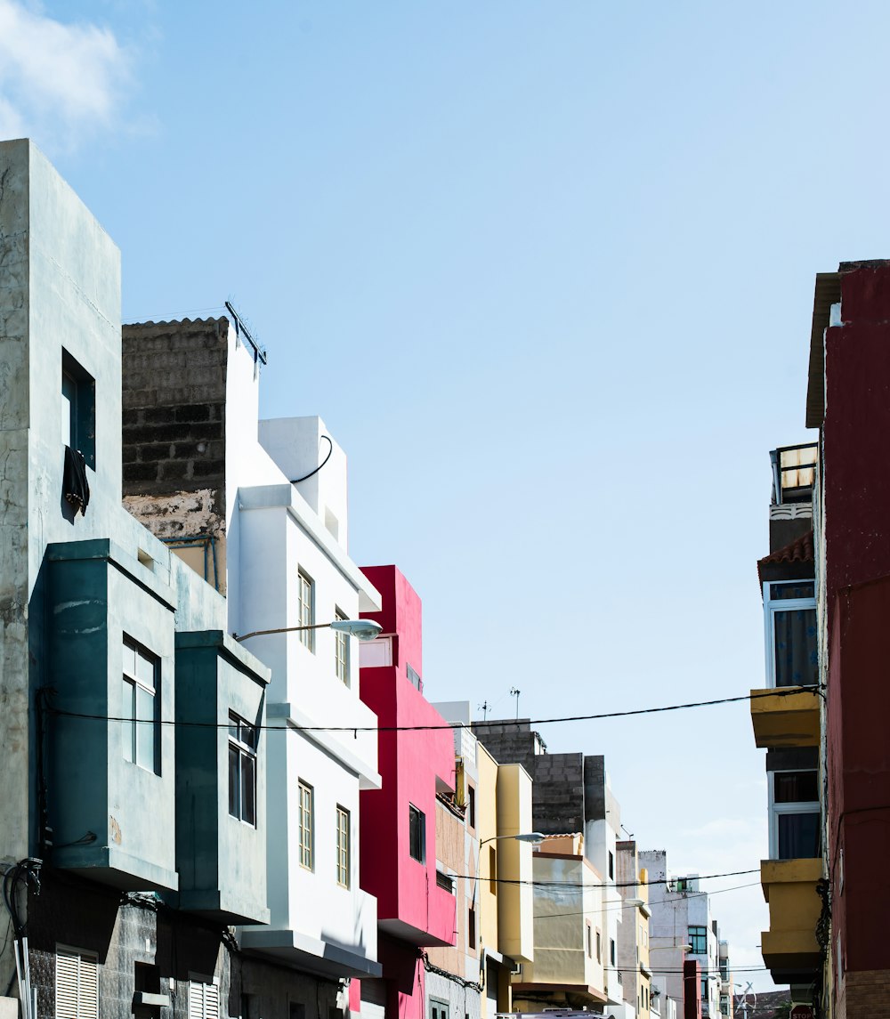 a row of multicolored buildings on a city street