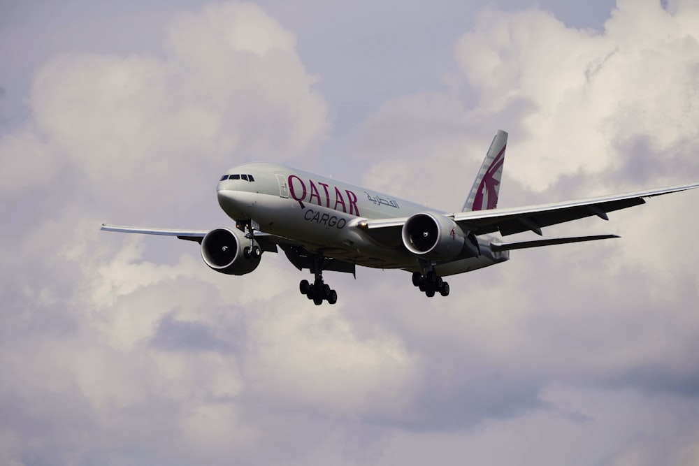 a large jetliner flying through a cloudy sky