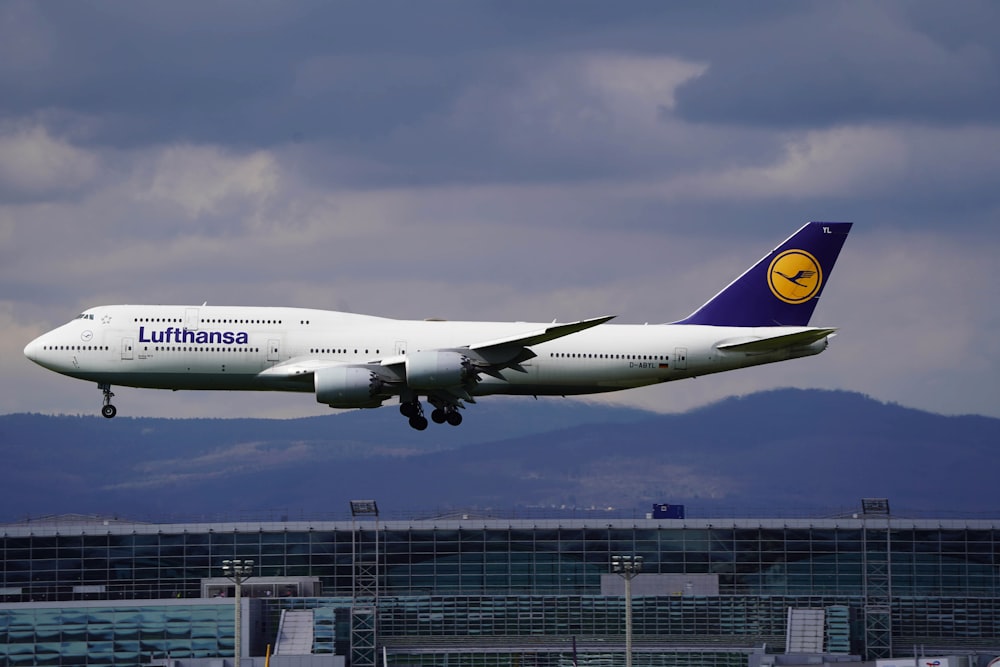 a large jetliner flying through a cloudy sky