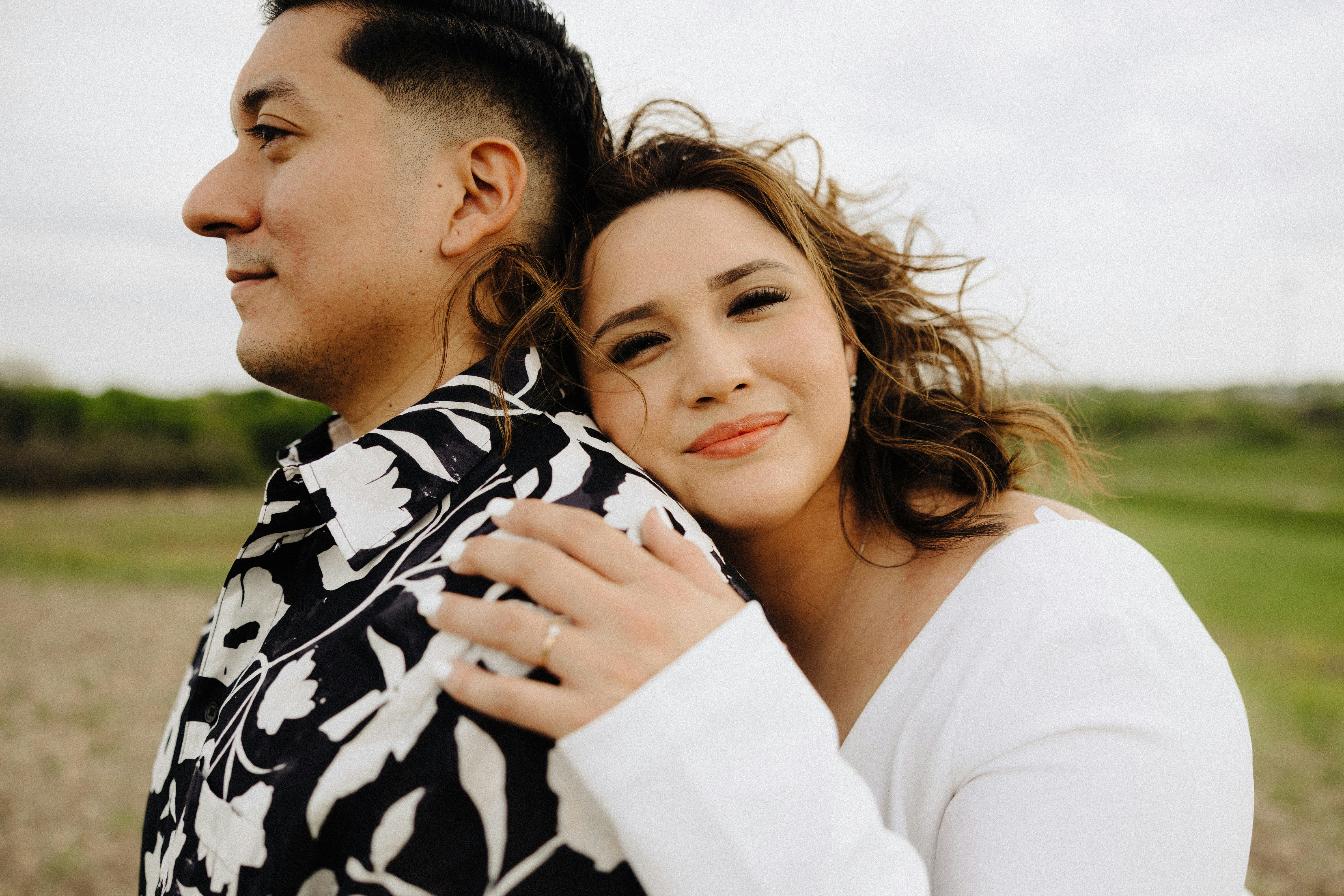 a man holding a woman in a field