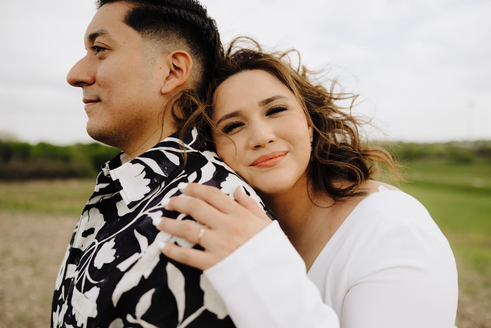 a man holding a woman in a field