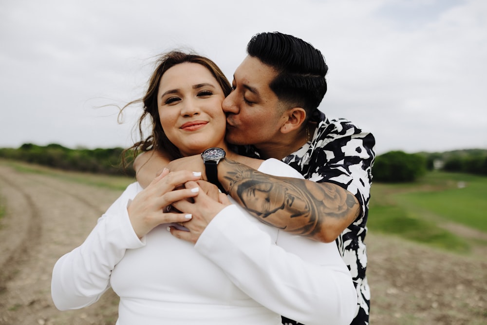 a man kissing a woman on the cheek