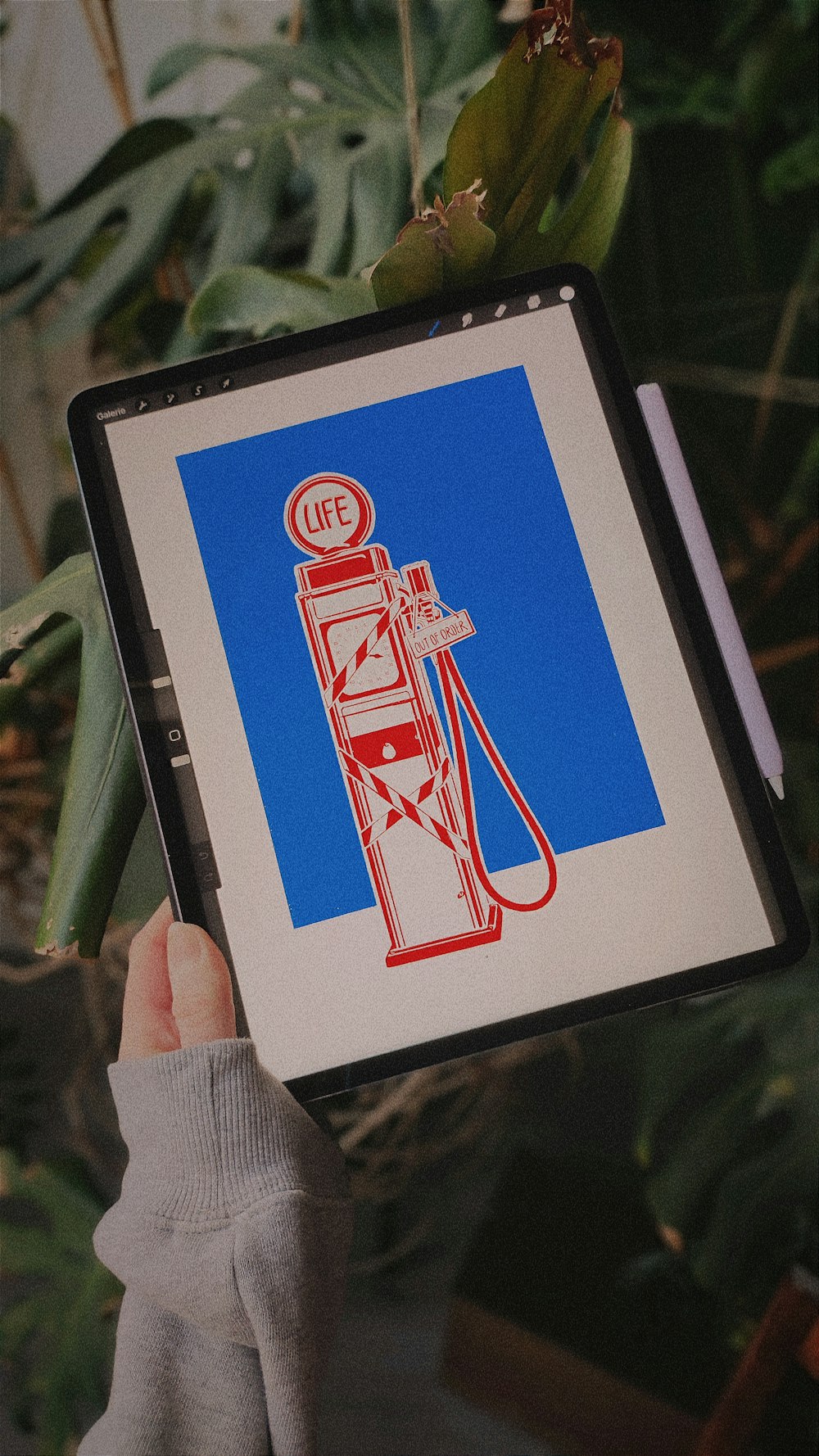 a person holding up a picture of a gas pump