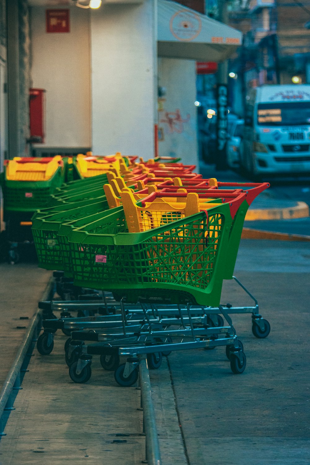 a row of green and yellow shopping carts
