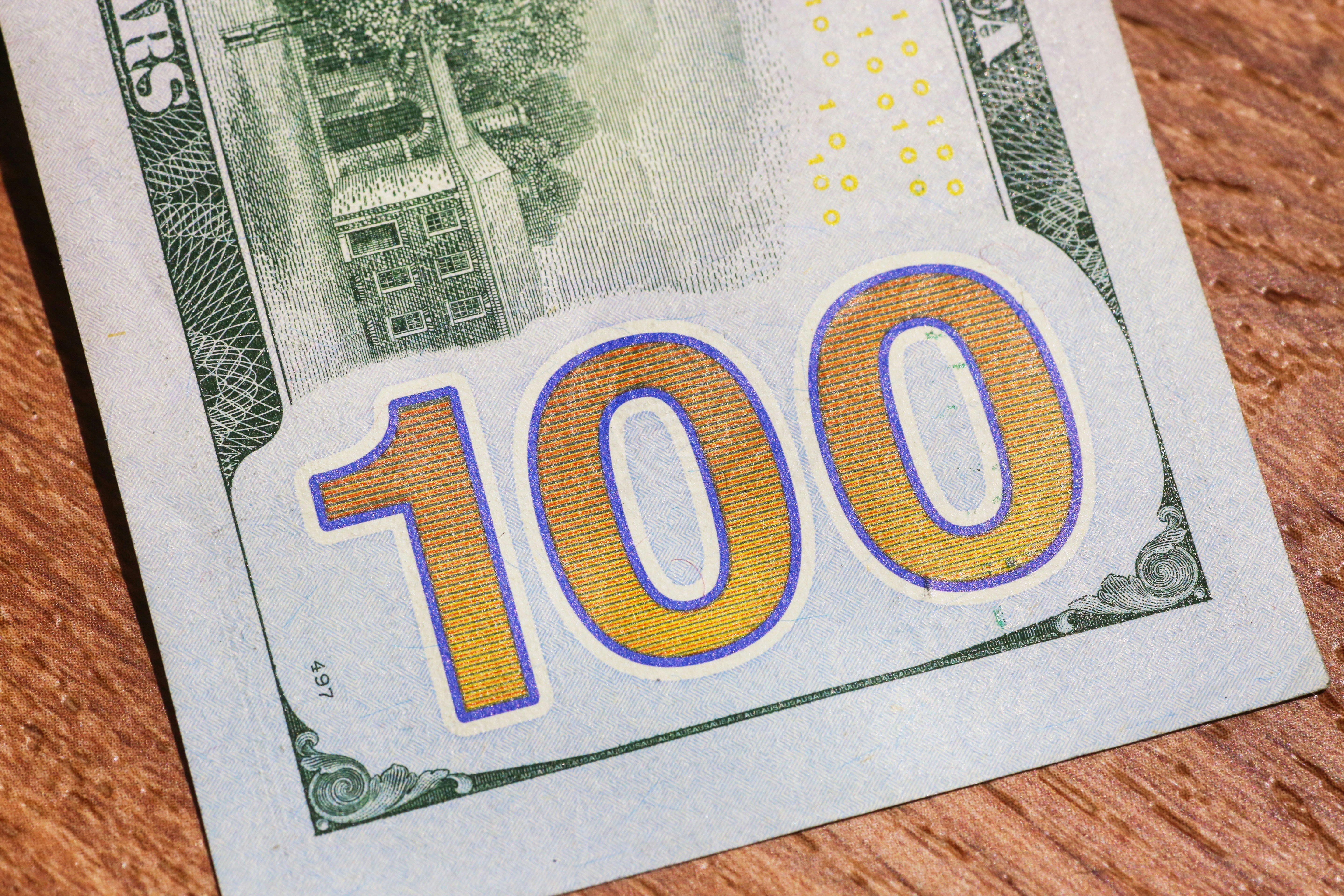 a hundred dollar bill with the number 100 on it