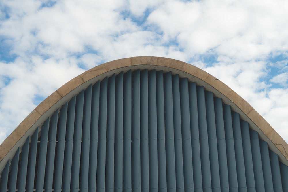 a curved building with a sky background