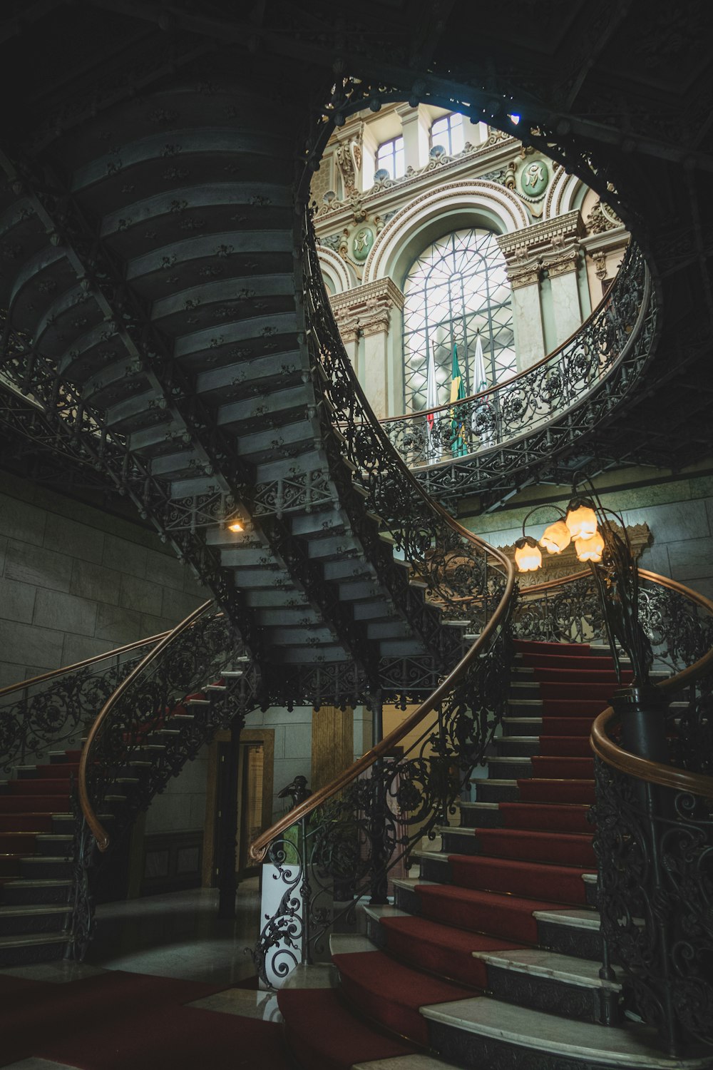 a spiral staircase in a building with a large window