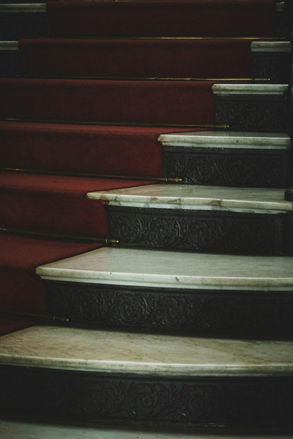 a close up of a set of stairs with red carpet