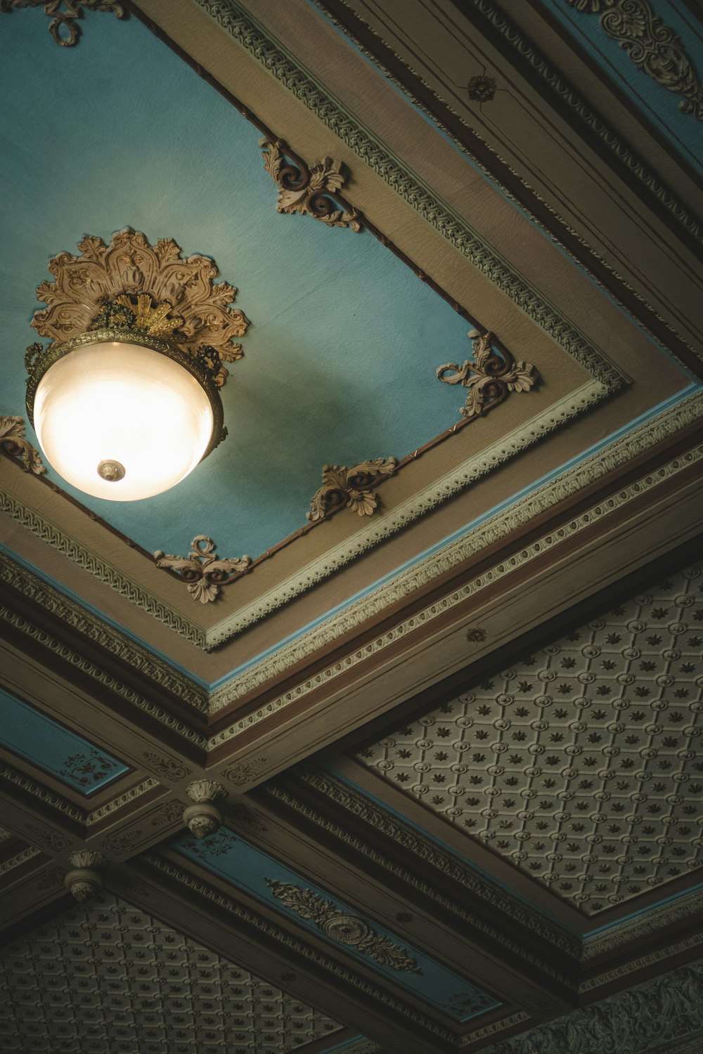 a ceiling with a light fixture and a blue ceiling