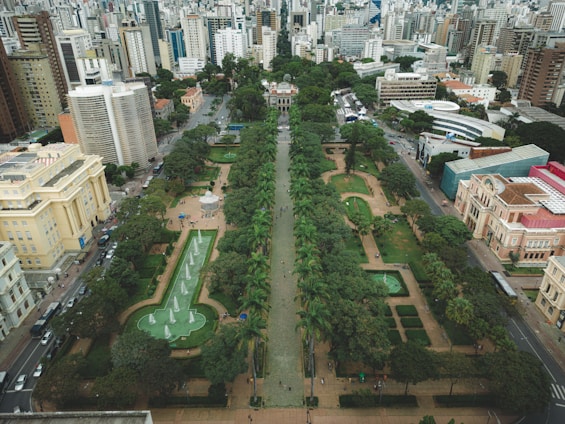 Aerial view of a green urban park surrounded by buildings.