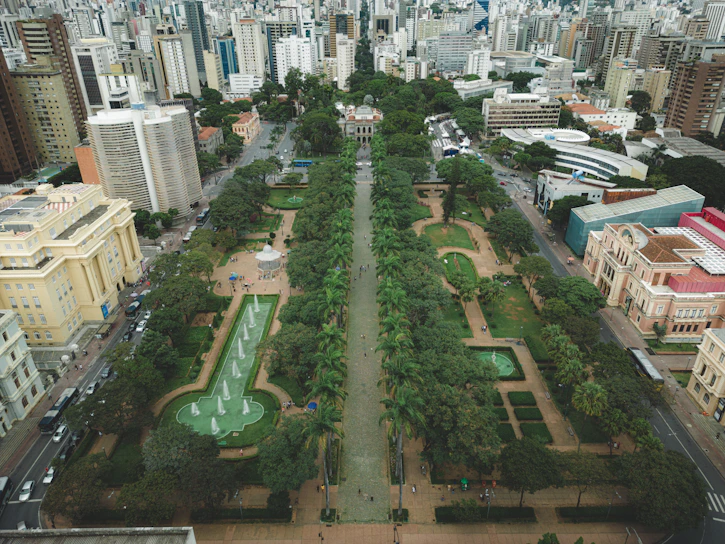 Aerial view of a sustainable urban park with green spaces and water features.