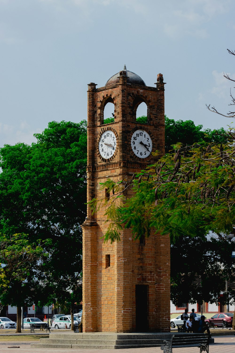 a clock tower with two clocks on each of it's sides