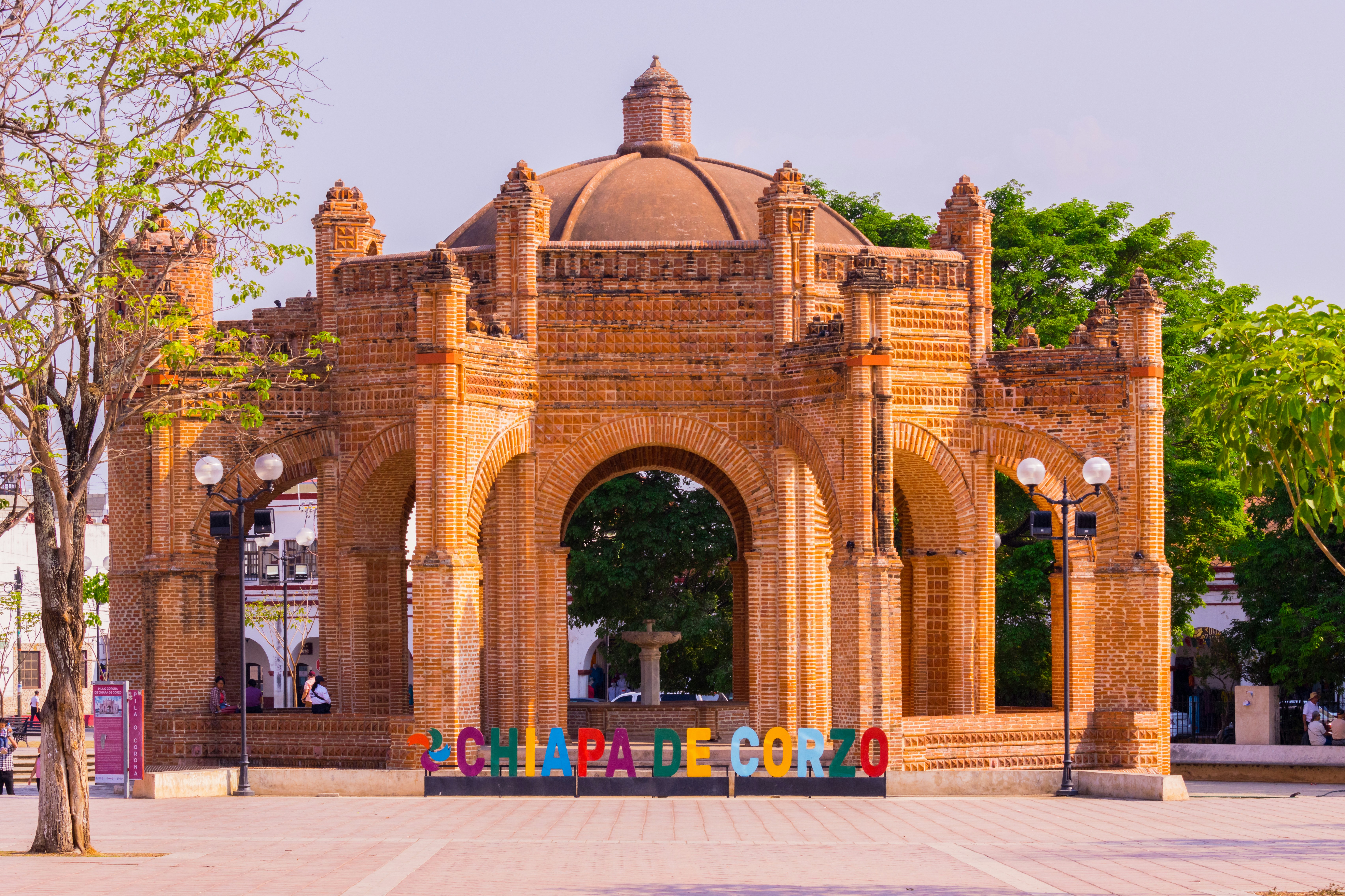 a brick building with a colorful sign in front of it, 