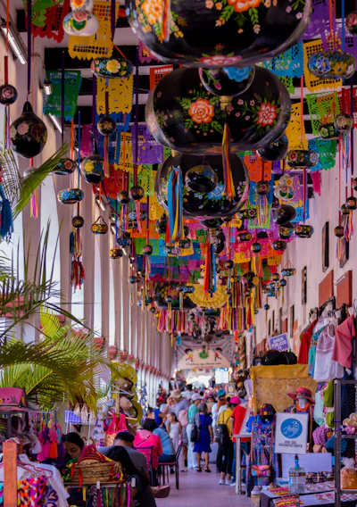 A vibrant Mexican street market in Australia with colorful decorations and smiling families.