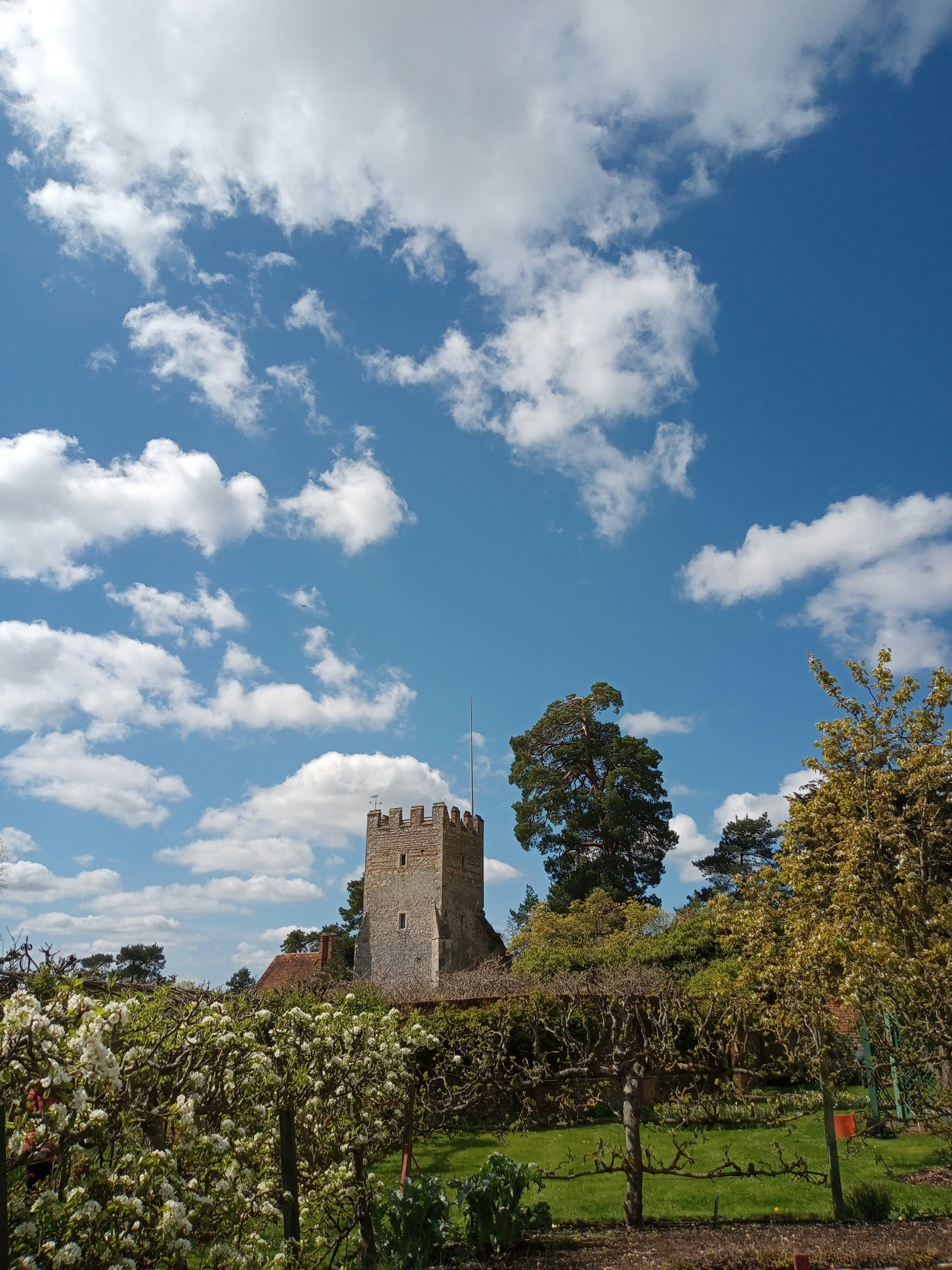 a tall tower sitting on top of a lush green field