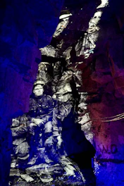 A dramatic black-and-white scene from a historical documentary enhanced with subtle colorization and AI effects.