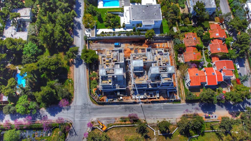 Before-and-after aerial comparison of a residential roofing project in progress.