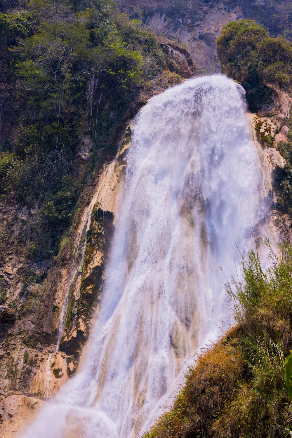 a very tall waterfall with lots of water coming out of it