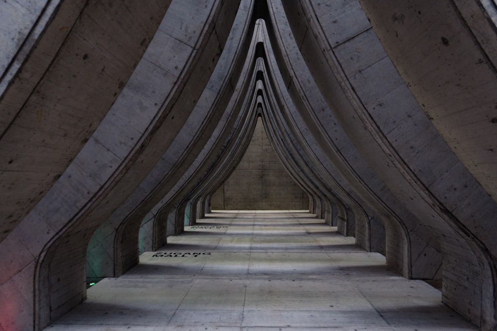 a long row of concrete structures with a red light at the end