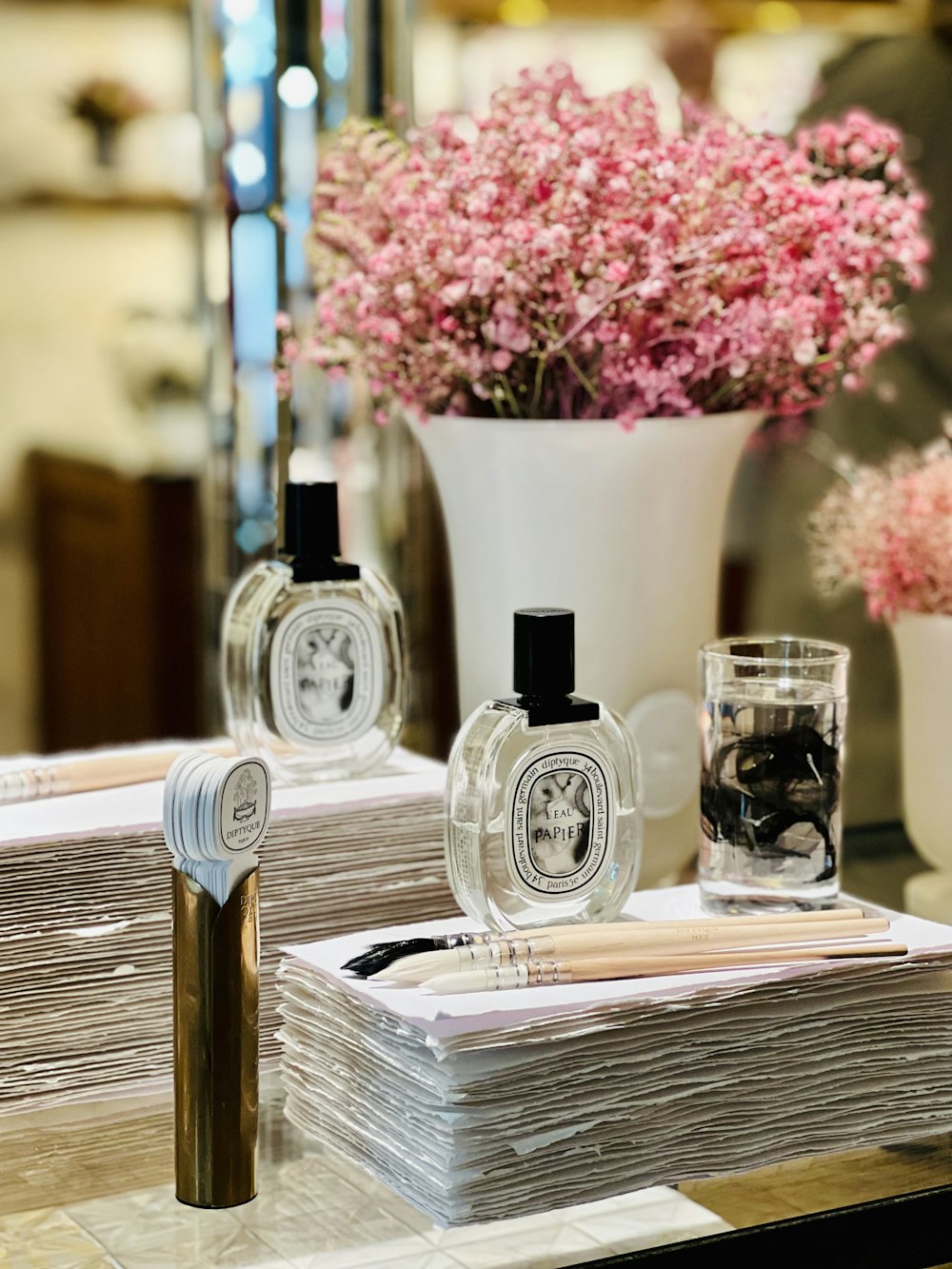 a table topped with lots of bottles of perfume