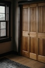 a room with a large wooden door and a window