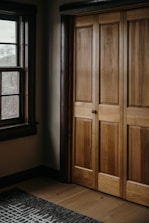 a room with a large wooden door and a window