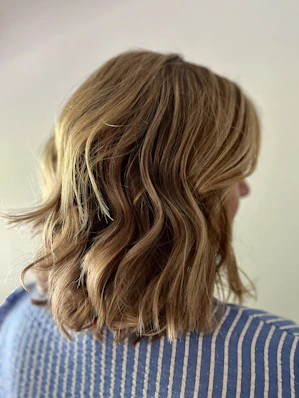 a close up of a person with wavy hair
