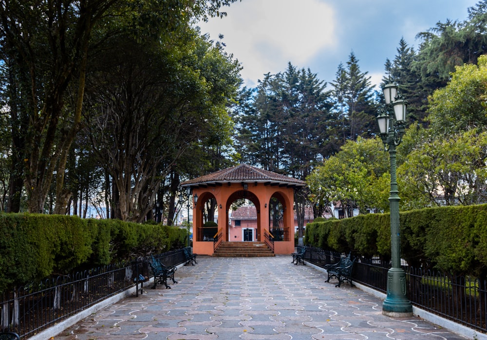 a gazebo in the middle of a park surrounded by trees