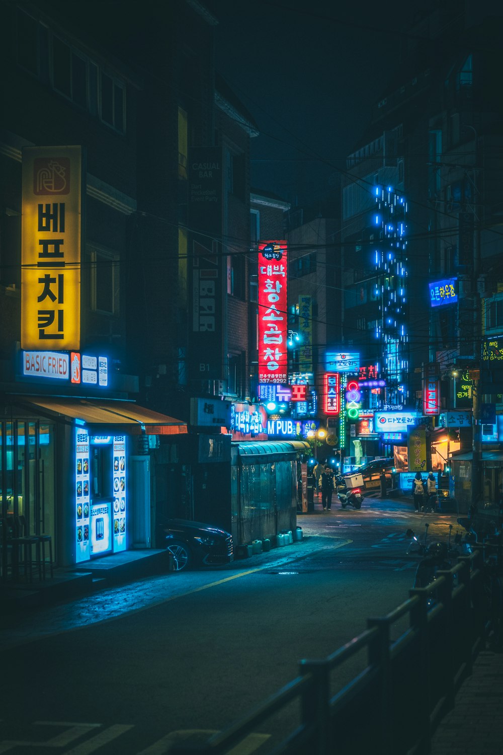 a city street at night with neon signs