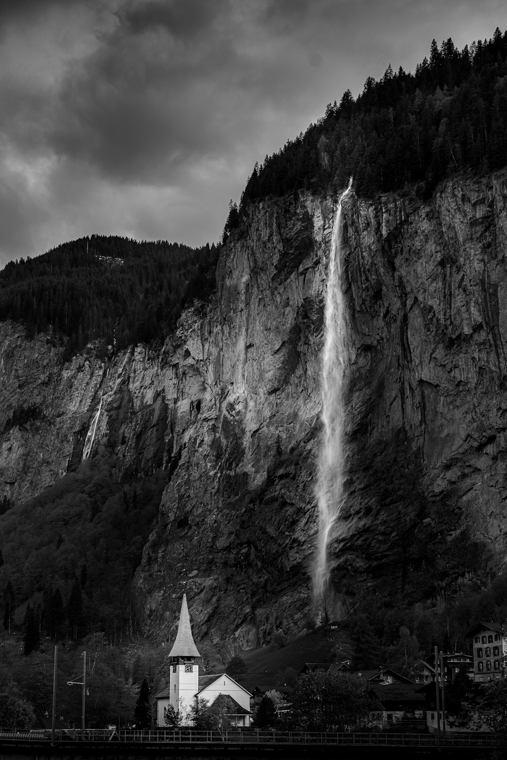 a black and white photo of a waterfall