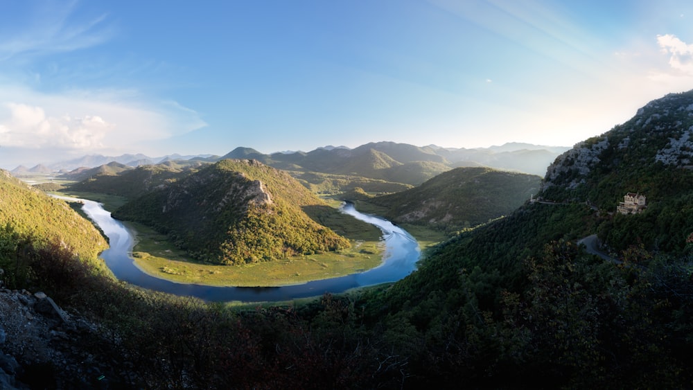 a river running through a valley surrounded by mountains