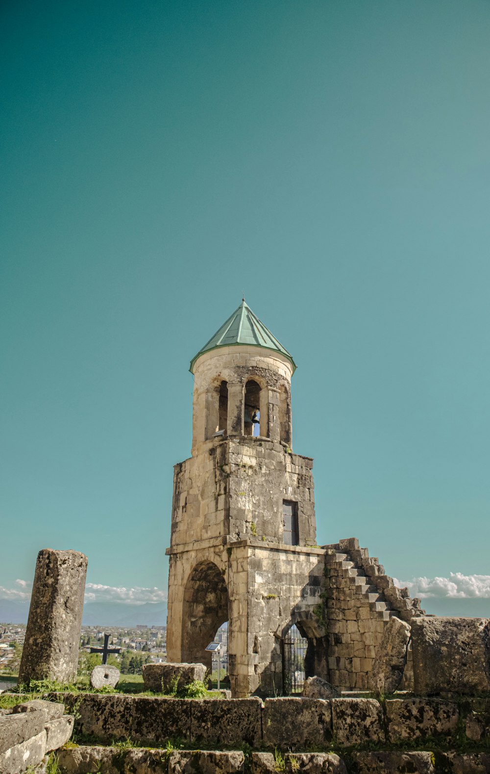 an old building with a green roof and a steeple