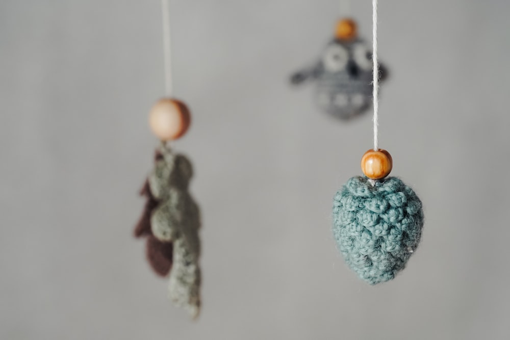 three crocheted ornaments hanging from a string