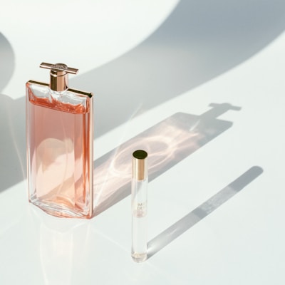 a bottle of perfume sitting next to a lighter