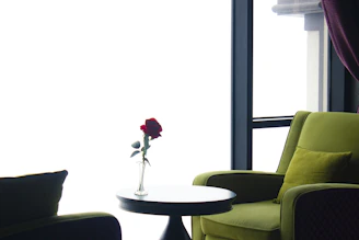 A quiet moment of reflection inside a cozy room decorated with red rose arrangements.
