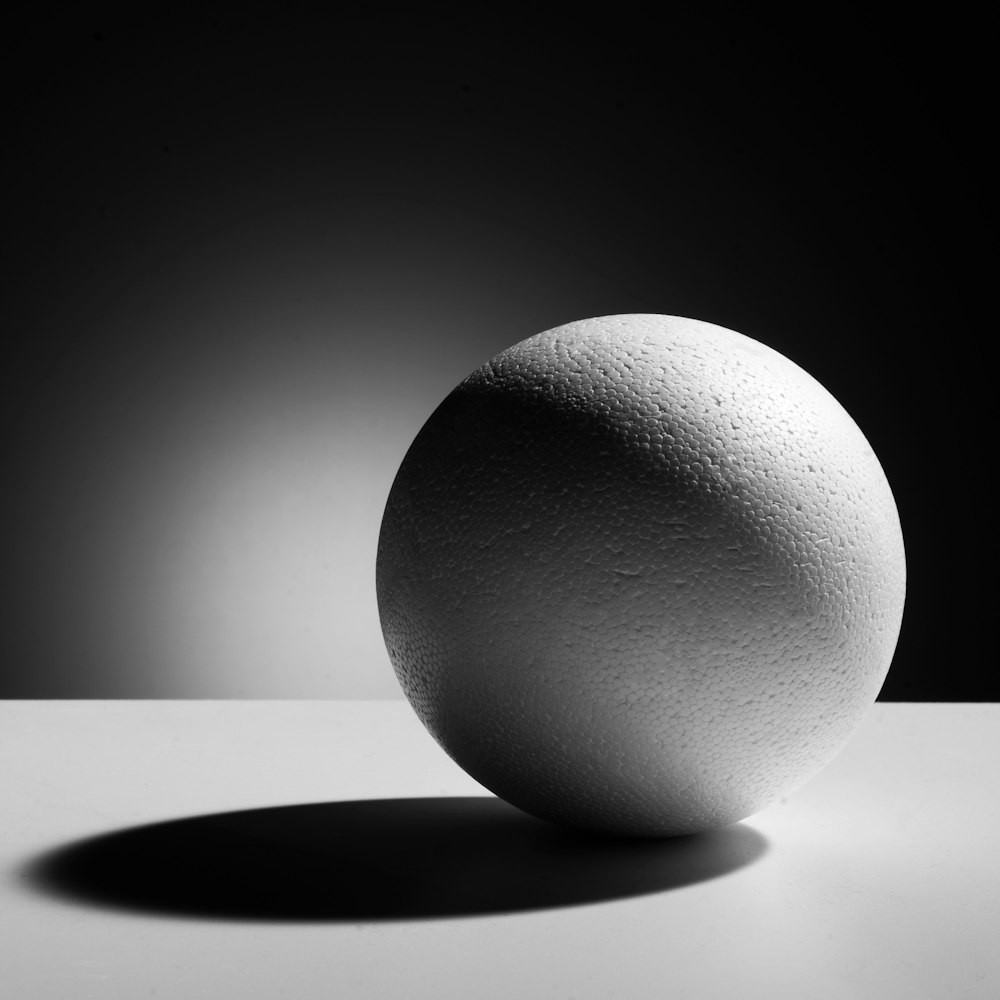 a white egg sitting on top of a table