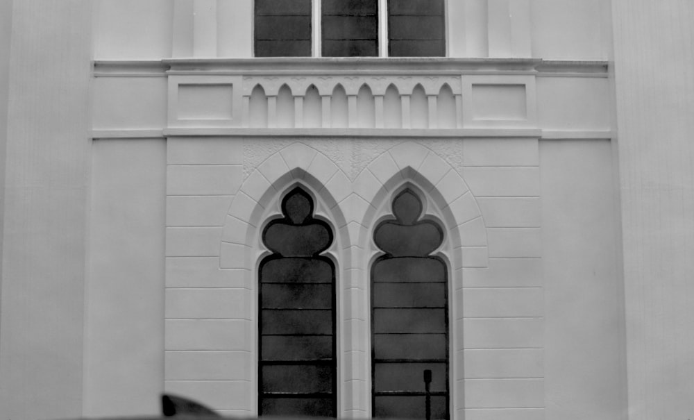 a black and white photo of a building with two windows
