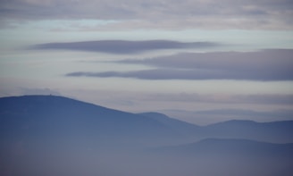 A serene misty blue landscape with soft cream accents.