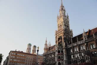 A freshly renovated tower clock shining under the afternoon sun with its restored gold accents.
