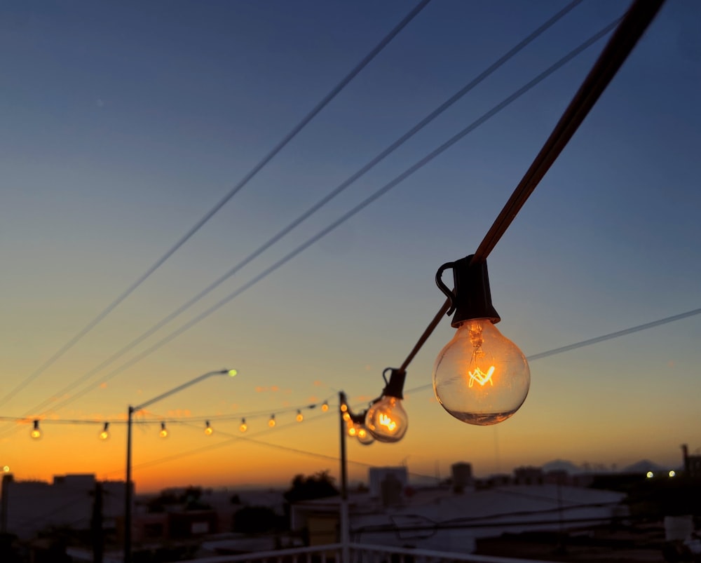 a string of light bulbs hanging from a power line