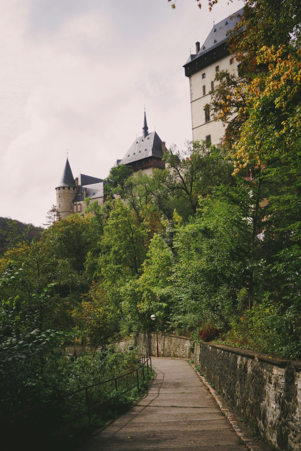 a walkway leading to a castle on a hill