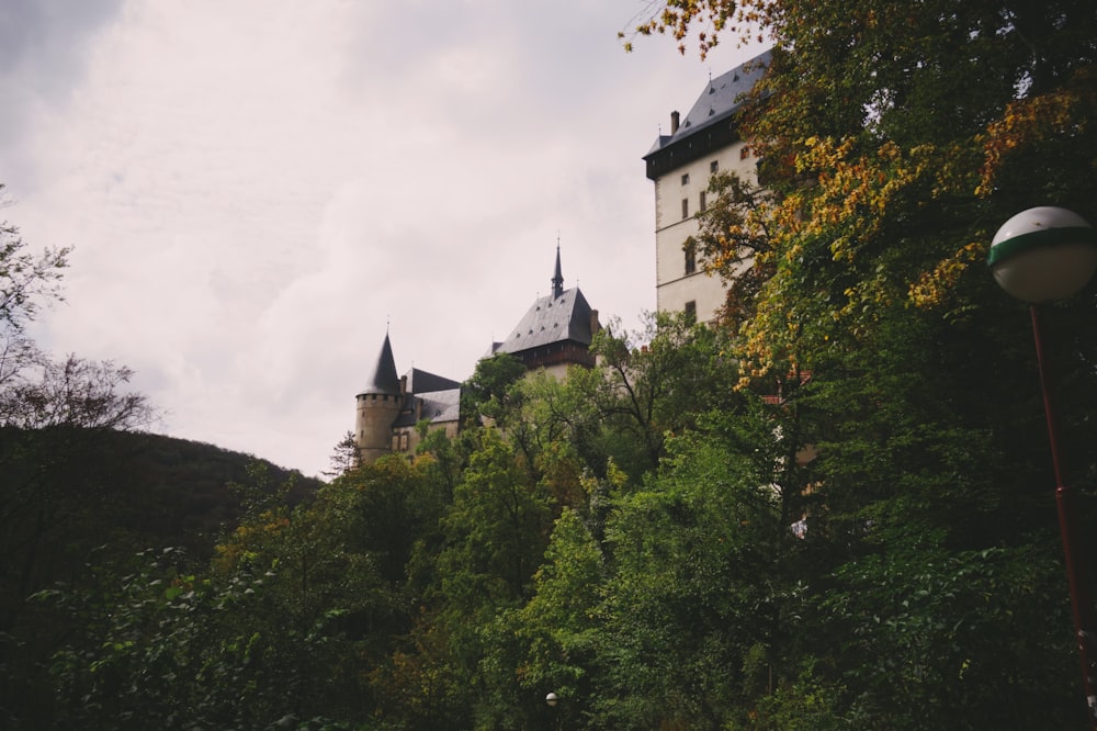 a castle on top of a hill surrounded by trees