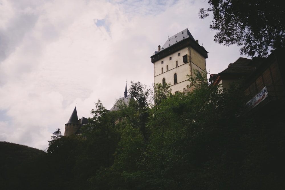 a castle on top of a hill surrounded by trees