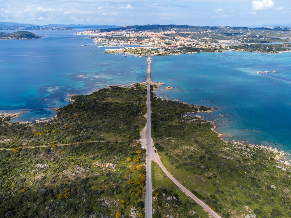 an aerial view of a road near a body of water