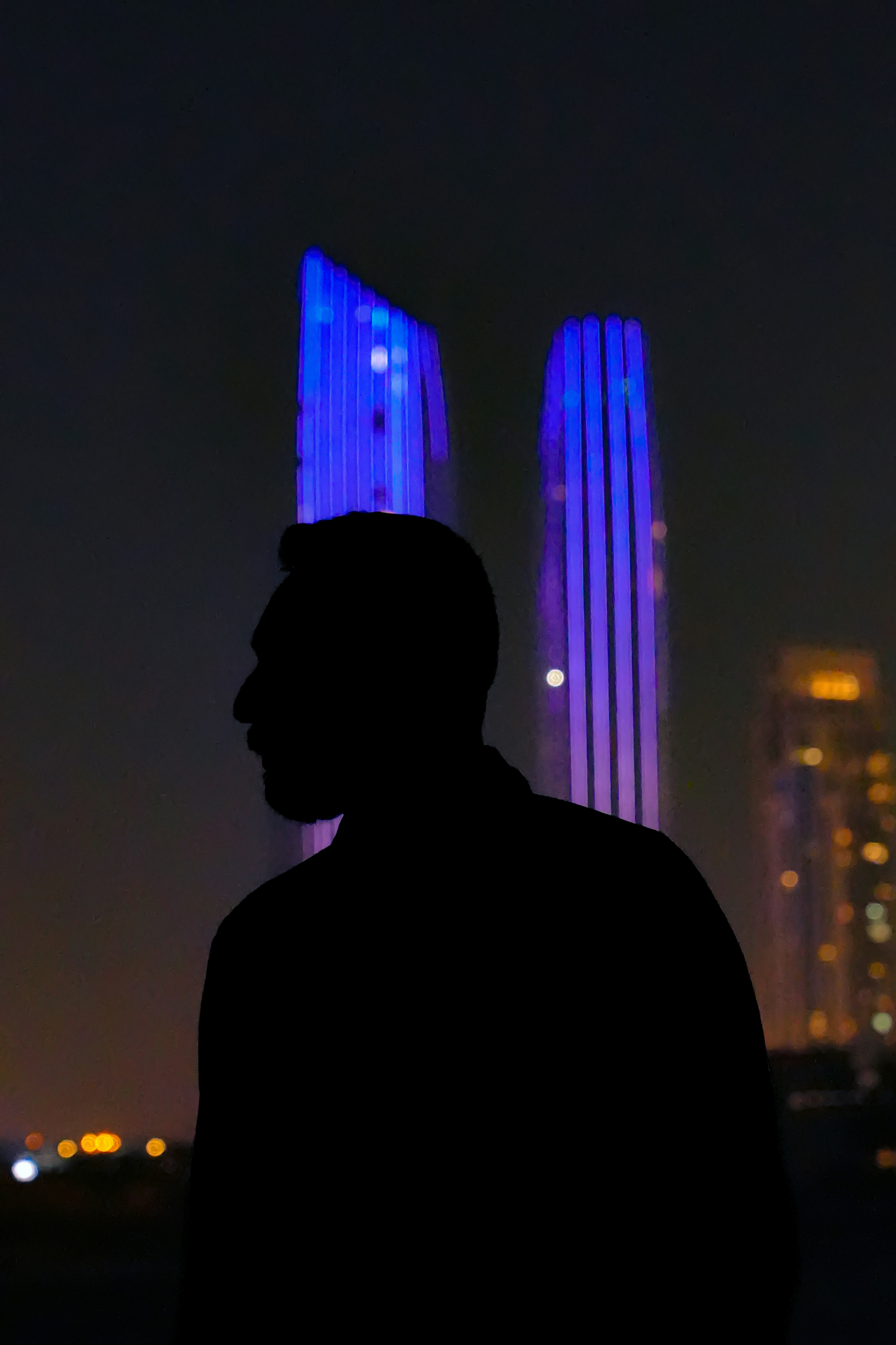 a man standing in front of a tall building