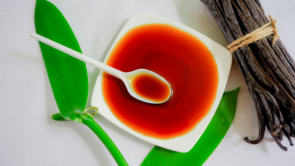 a spoon is in a bowl of red liquid