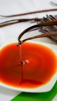 a small white plate with a red sauce on it