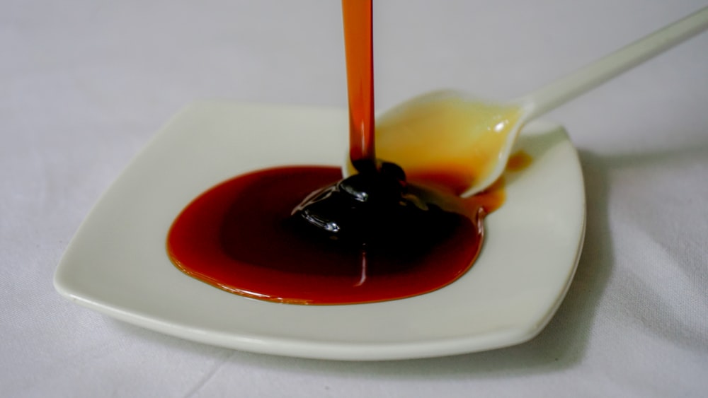 a white plate topped with sauce and a spoon